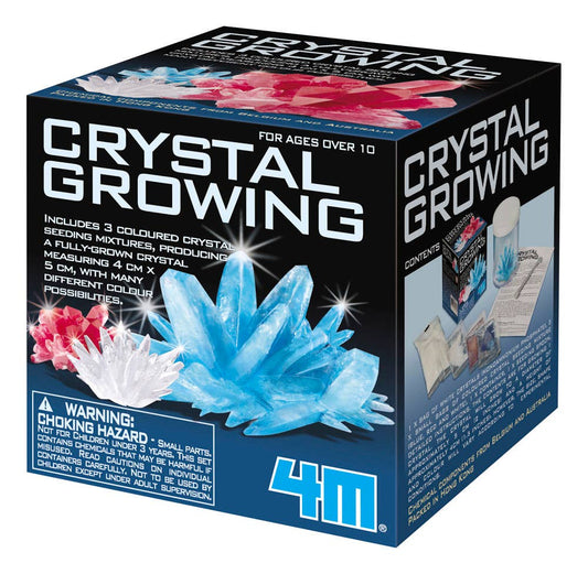 The 4M Crystal Growing Easy STEM Science Experiment kit by Toysmith comes in a black box adorned with images of blue and red crystals. The front of the box displays the text "Crystal Growing" and highlights included contents such as colored crystal mixtures and a crystal display base. Designed for children aged 10 years and older due to small parts, it also carries a choking hazard warning for children under 3 years.