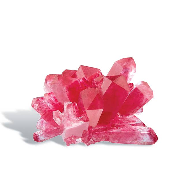 Displayed against a plain white background is the vibrant result of the 4M Crystal Growing Easy STEM Science Experiment by Toysmith. The pink crystal formation features multiple jagged, translucent points that vary in size and shape. This visually striking and symmetrical arrangement perfectly showcases the enchanting creations you can achieve with our crystal growing kit.