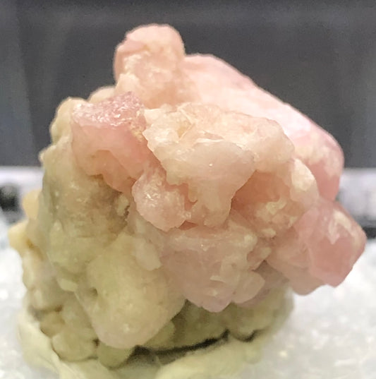 A light pink Grossular Garnet from Morelos, Mexico by The Crystalary, showcases a crystalline texture and complex facets in this auction item.