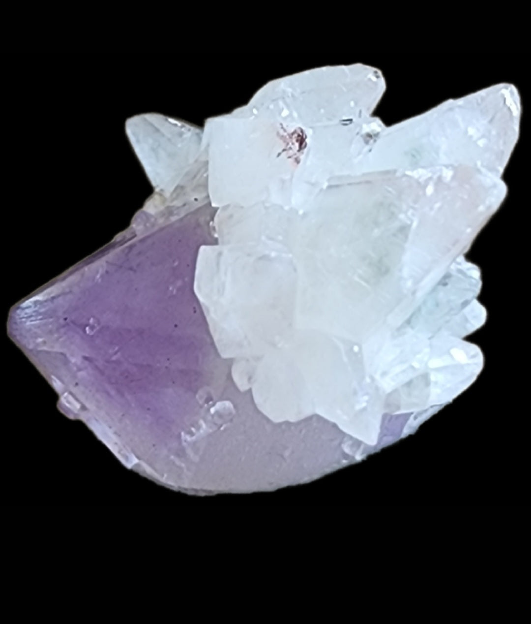 Close-up of a raw Quartz v. Amethyst, Calcite cluster from the Tonglushan Mine by The Crystalary, showcasing irregular, translucent purple and white crystals against a black background. Sharp angles highlight the natural beauty of sku 3103's remarkable formations.