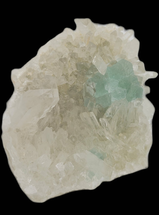 A close-up showcases Fluorite with Quartz from the Huayllapon Mine, Peru (SKU 801) by The Crystalary. Translucent mint green fluorite and clear quartz crystals boast a rough texture against a solid black background, highlighting their color and intricate details.