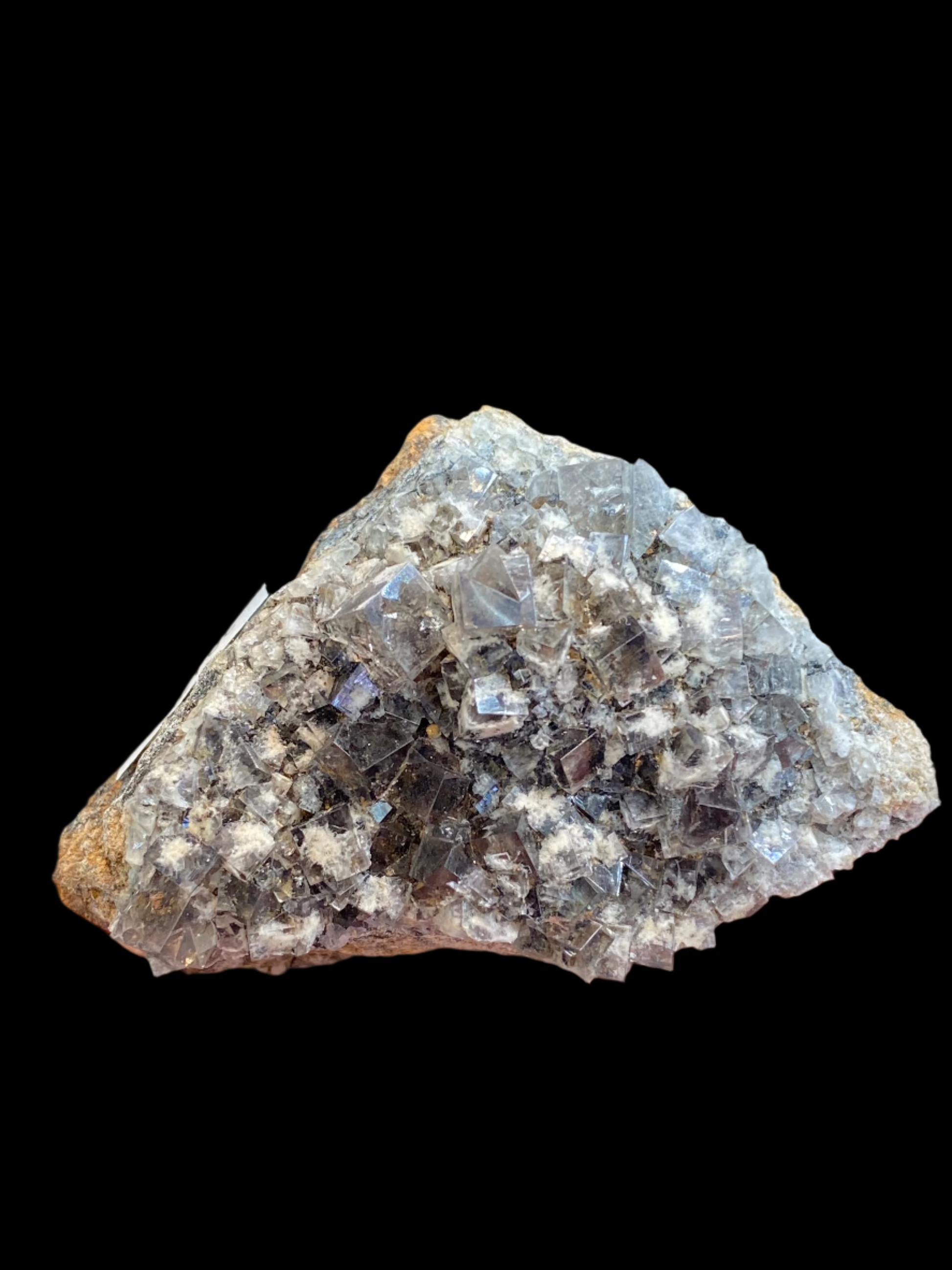 A person holds a breathtaking Fluorite-Smoky Rabbit Pocket specimen from the Diana Maria Mine, part of The Crystalary collection. This piece, identified as sku3017, features a rough crystalline surface in shades of gray and white. Its angular, glass-like facets are beautifully showcased against a blurred background, highlighting its natural allure.