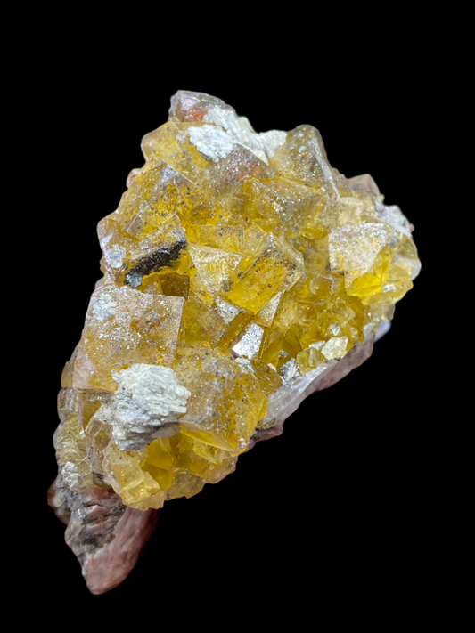 A close-up of a hand holding a cluster of yellow fluorite from the Heißer Stein Mine in the Schwandorf District, Bavaria, showcases their rugged, geometric texture. The crystals have a glassy, translucent appearance against a softly blurred background. Brought to you by The Crystalary (SKU: 3032).