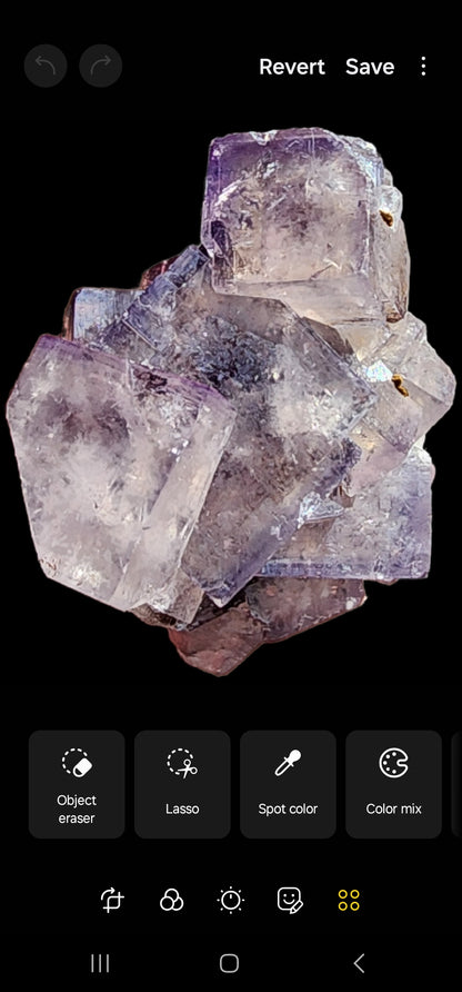 A glassy cluster of purple and clear cubic crystals from The Crystalary's Fluorite - Cromwell Pocket collection, originating from Greenlaws Mine, Daddry Shield, Stanhope, Co. Durham, England (copy), is displayed against a black background. The crystals exhibit a mix of rich purple tones and some translucent sections reminiscent of those found in County Durham. Image editing options including "Object eraser," "Lasso," "Spot color," and "Color mix" are visible at the bottom of the screen.