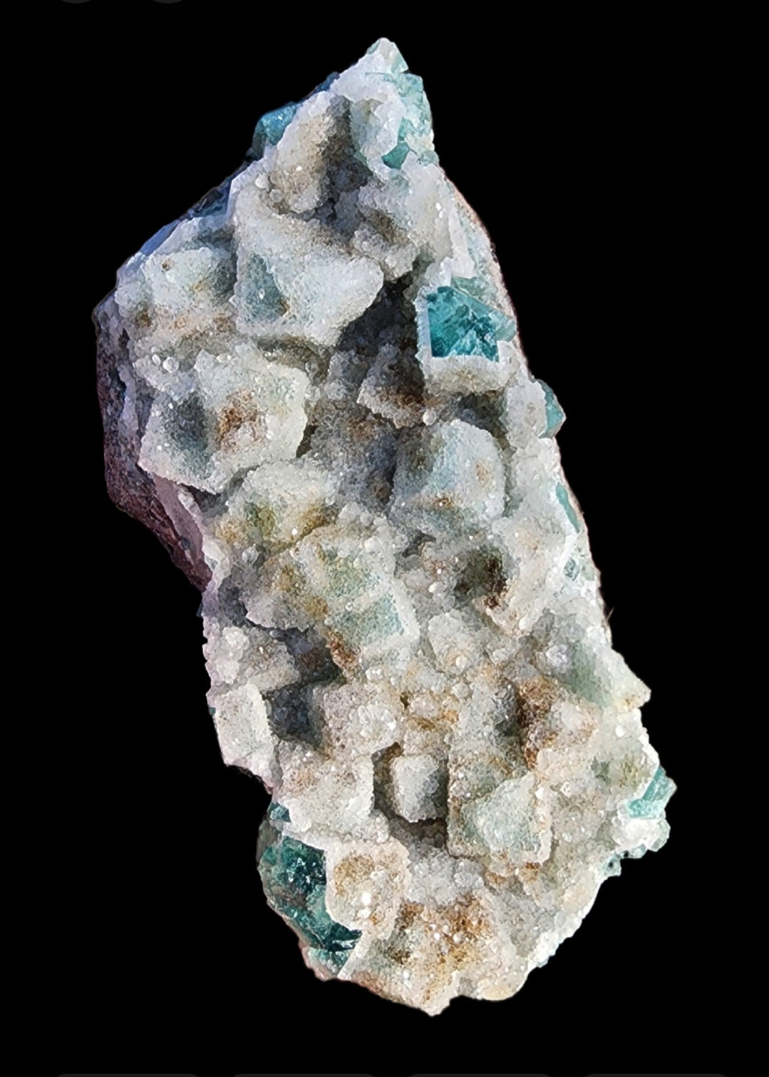 A specimen from The Crystalary, named "Fluorite with Quartz- Druzy Dreams Pocket," features light green cubic fluorite crystals on a creamy white mineral matrix from Rogerley Mine, Frosterley, Weardale, Co. Durham, England (sku11). These translucent crystals are set against a black background and display visible specks and variations in color.