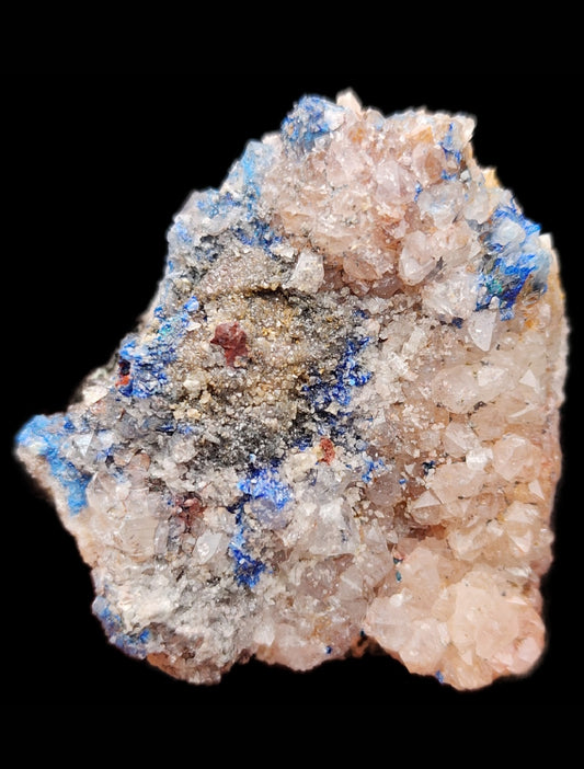 The Crystalary's Linarite, Quartz specimen from Sunshine #3 1/2 Adit, Blanchard, Socorro County, New Mexico (SKU: 3033), showcases a close-up of crystalline formations. The predominantly clear Quartz crystals subtly display hints of pink, accented by the blue and dark specks characteristic of Linarite, all creating a vibrant and intricate geode against a black backdrop.