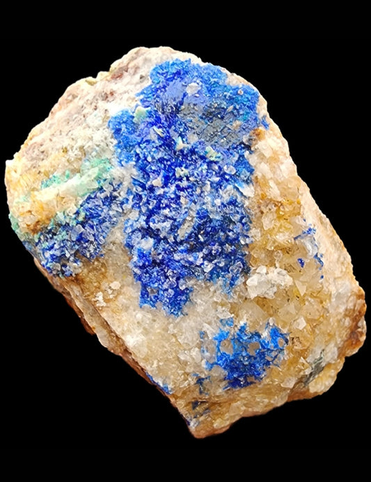 This mineral specimen, reminiscent of stunning Linarite, features a mix of white, beige, and vivid blue crystals from the Sunshine #3 1/2 Adit in Blanchard Mine. It is presented against a black background and is available under SKU 3034 from The Crystalary.