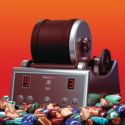 A Dan&Darci Advanced Rock Tumbler is displayed against a gradient orange background. The machine features a digital control panel showing "9" days and "3" speed settings. Polished gems in various colors and patterns are scattered in front of the tumbler, showcasing the beauty of rock tumbling.