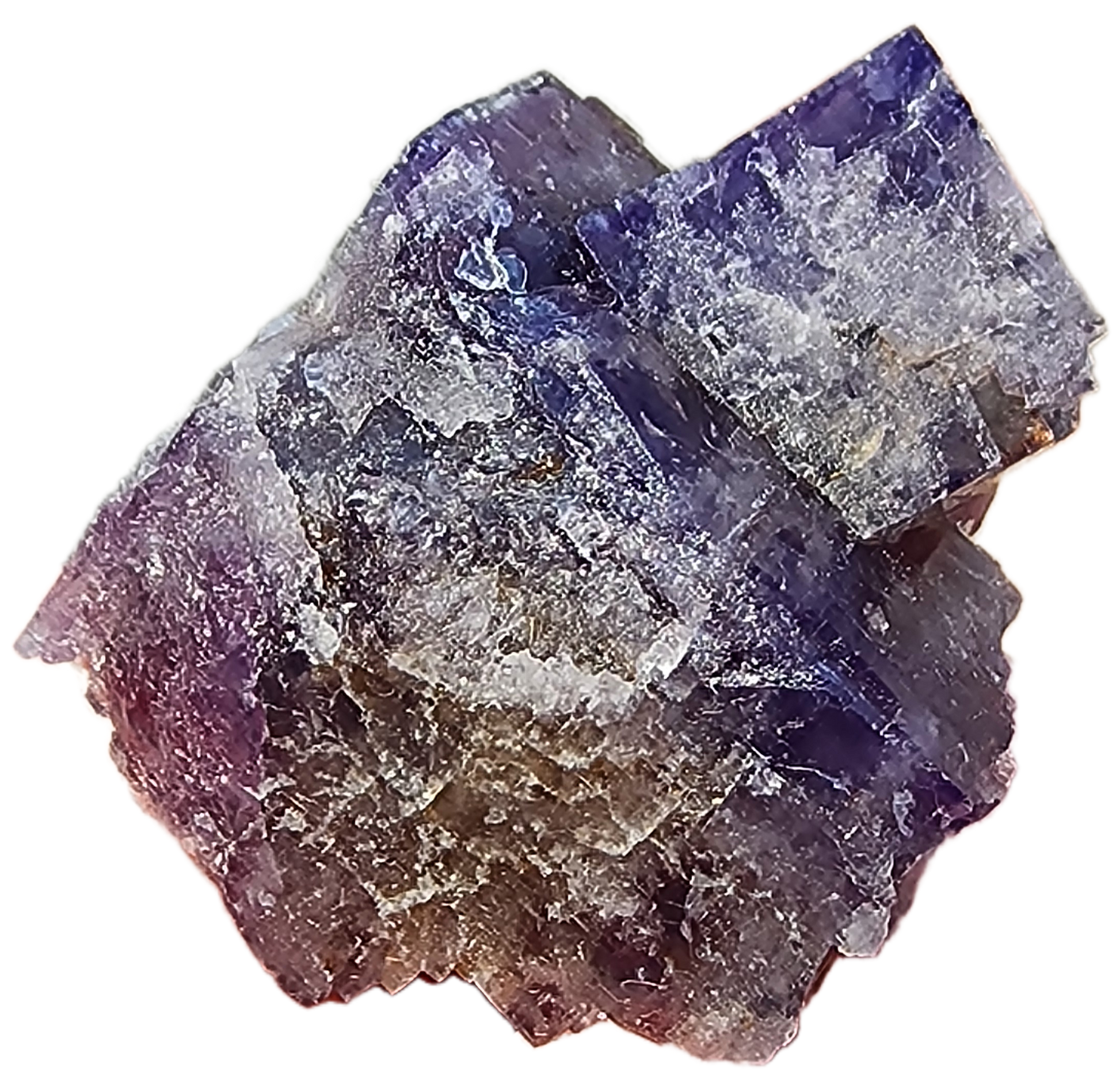 A rough piece of Fluorite- Purple Haze Pocket from the Diana Maria Mine in Rogerley, Weardale, England, displaying various shades of purple and a striking crystalline structure. It has a jagged, irregular surface with some translucent and some opaque areas. The edges are sharp and angular, contributing to its raw and rugged appearance. This exquisite mineral specimen is offered by The Crystalary.