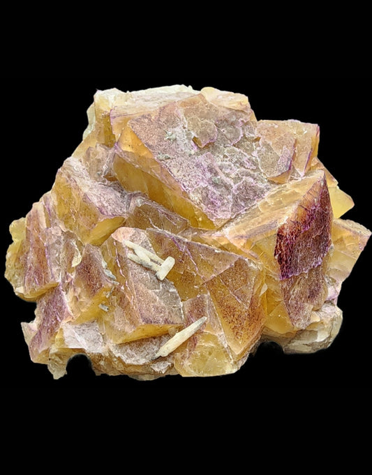 A stunning **Fluorite- Rosiclare Mine, Rosiclare, Hardin County, Illinois, USA** specimen from **The Crystalary** showcases a cluster of yellow and purple crystals in a roughly polygonal structure. Featuring sharp and layered edges, its uneven surface reveals areas of translucence and striking color variations against a black background.