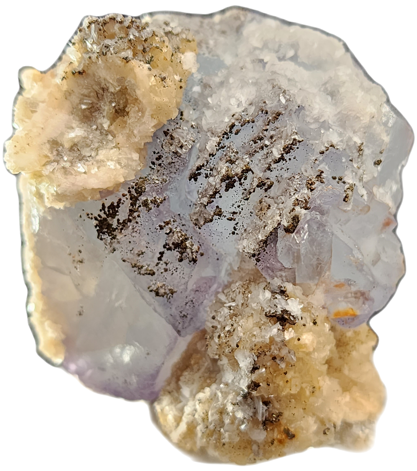 A close-up image of the mineral specimen Fluorite, Yaogangxian by The Crystalary showcases a translucent, pale lavender crystal with a rough texture. The crystal is accented with dark specks and encircled by beige and white crusty formations, resulting in a rugged and variegated appearance.