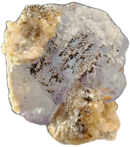 A close-up image of the mineral specimen Fluorite, Yaogangxian by The Crystalary showcases a translucent, pale lavender crystal with a rough texture. The crystal is accented with dark specks and encircled by beige and white crusty formations, resulting in a rugged and variegated appearance.