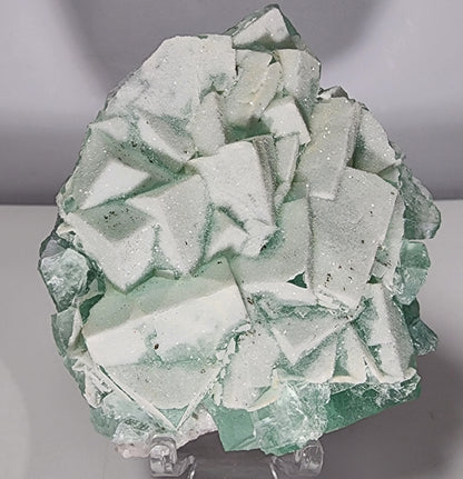 A striking piece of Fluorite-Yaogangxian with Mico "Sugar" Quartz from The Crystalary, showcasing angular, predominantly light green fluorite crystals adorned with frosty white calcite and sugary micro quartz that lend a textured, sparkling appearance. Weighing in at 248 grams, it's displayed beautifully against a plain backdrop.