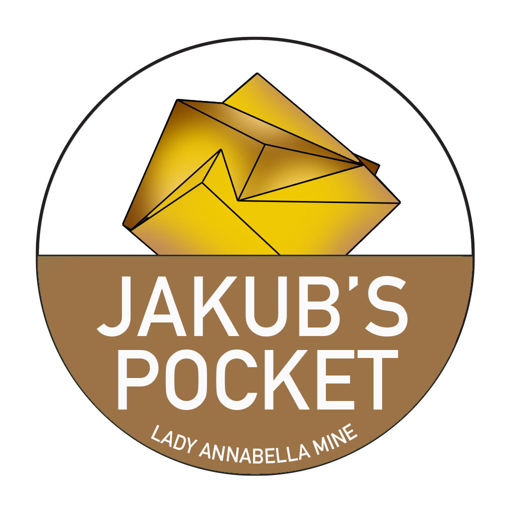 Add a vibrant logo to your collection with The Crystalary's Lady Annabella Passport Stickers. Each sticker features a yellow, faceted crystalline structure inside a white circle, with a brown semi-circle at the base. The text in the brown area reads "JAKUB'S POCKET" with "LADY ANNABELLA MINE" beneath it in smaller letters. Perfect for any Fluorite enthusiast!