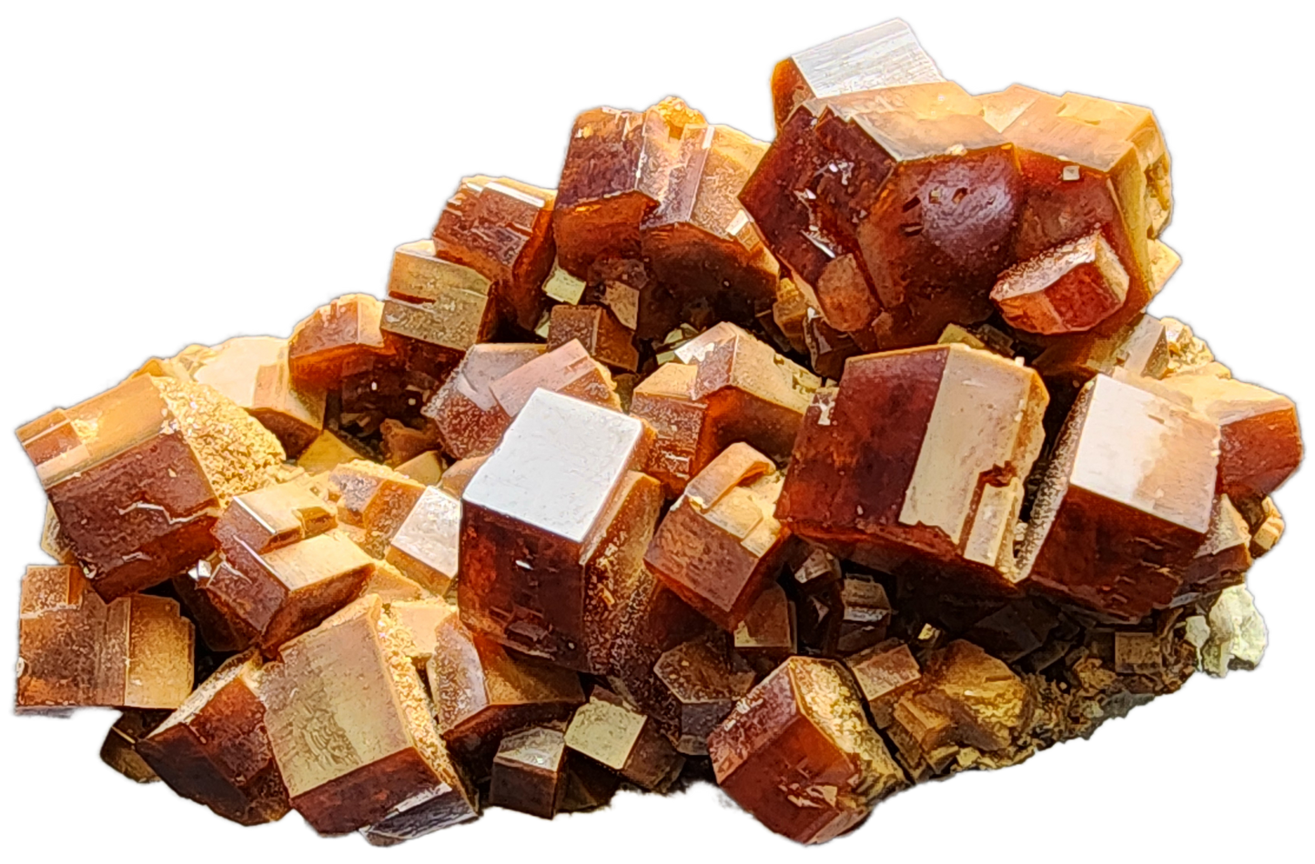 A close-up view of the Vanadinite from The Crystalary, sourced from the Mibladen mining district in Midelt Province, Drâa-Tafilalet Region, Morocco (sku 3076). This piece showcases a cluster of reddish-brown crystals with rectangular shapes, layered to reveal a shiny and reflective surface. The image emphasizes the intricate geometric patterns and textures of this stunning mineral specimen.